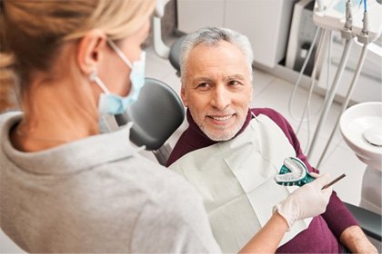 a denture candidate smiling at his dentist