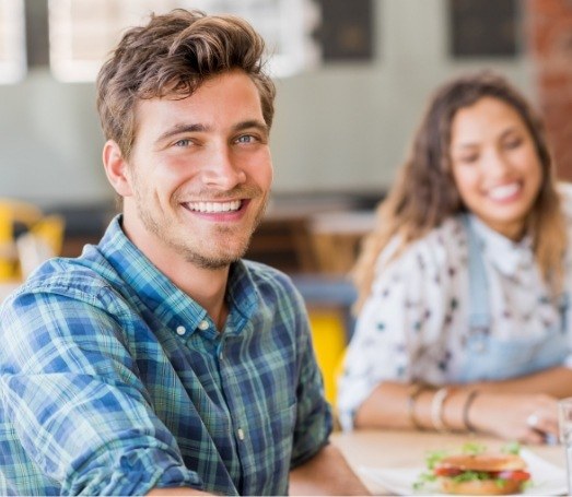 Smiling man in blue plaid shirt