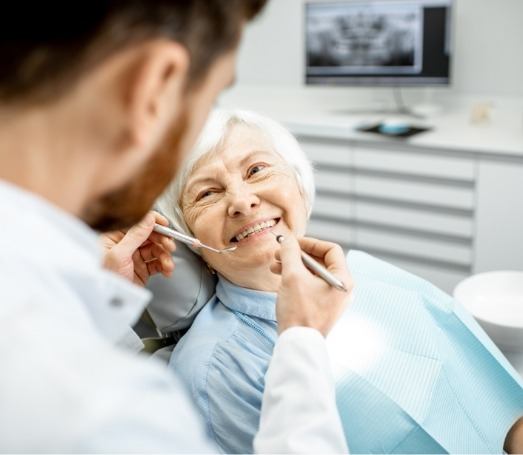 Senior woman smiling at her cosmetic dentist