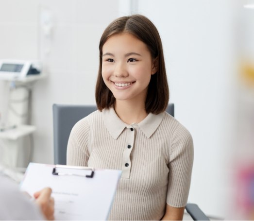 Woman smiling at her dentist during dental checkup