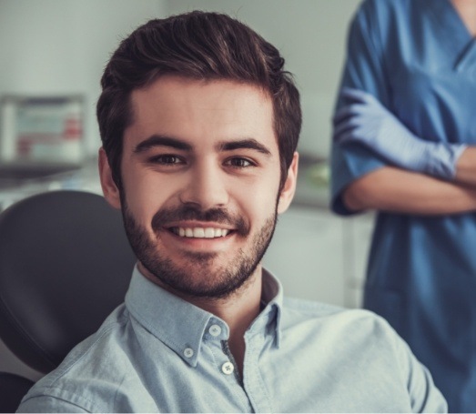 Man with short beard smiling in dental chair