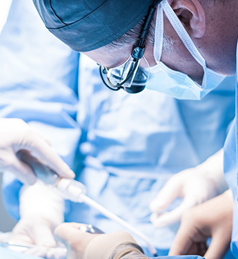 Dentist performing dental implant surgery