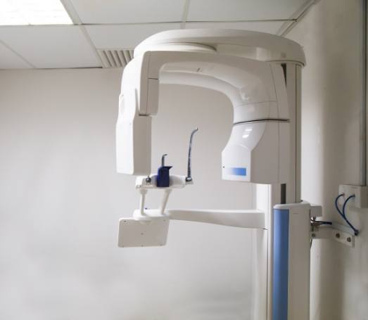 Cone beam C T dental scanner against white wall