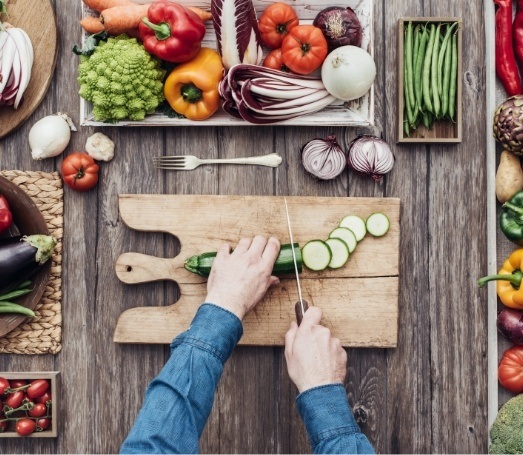 Person cutting vegetables on cutting board