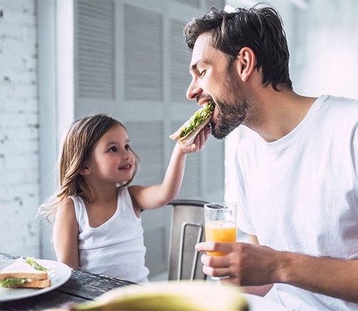 Father eating lunch with daughter