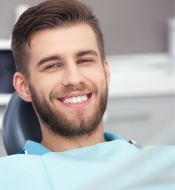 Young man smiling in dental chair