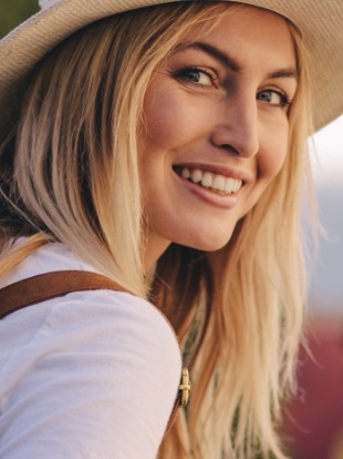 Smiling blonde woman in sunhat