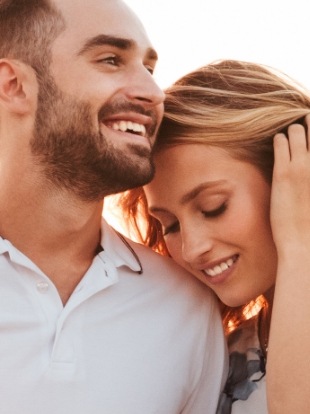 Woman resting her head on shoulder of man next to her