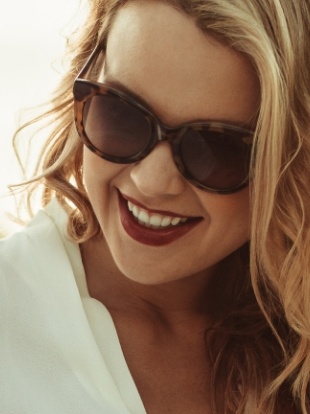 Smiling blonde woman in sunglasses