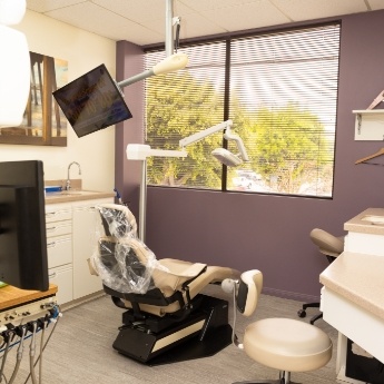 Dental exam room with window showing trees