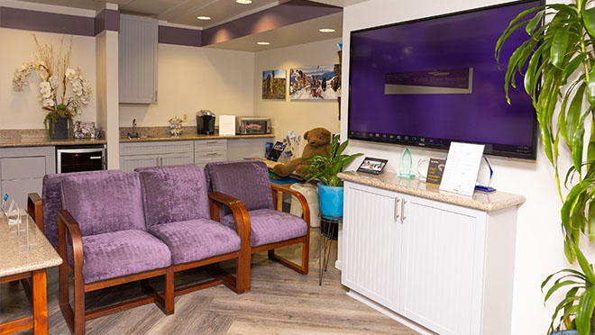 Three purple chairs in waiting area of Los Angeles dental office