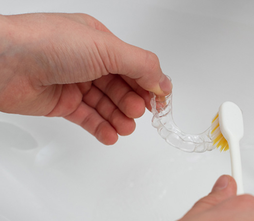 Patient cleaning aligner in sink