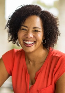 Woman in red blouse smiling