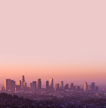 Pink sky over city skyline