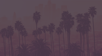 Palm trees against foggy purple sky