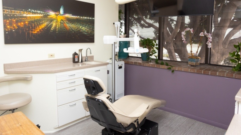 Dental exam room with photo of city lights at night on wall