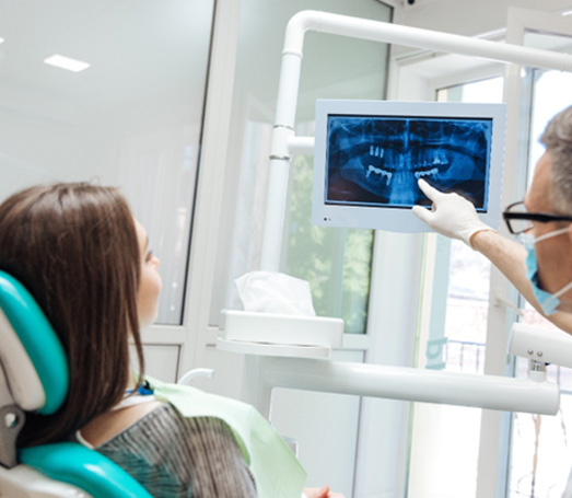 Dentist going over X-ray with patient
