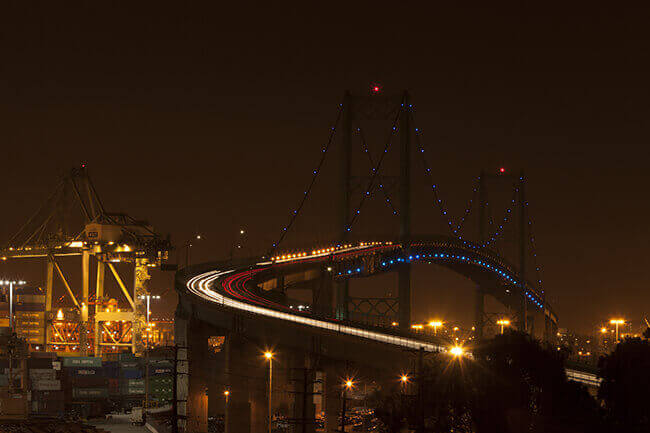Blue lights on drawbridge strings at night