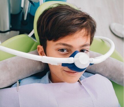 Smiling young boy wearing nitrous oxide sedation mask