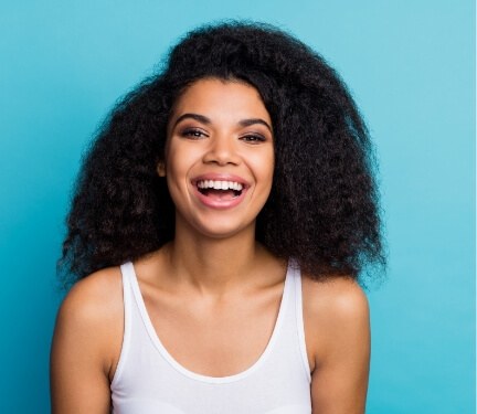 Smiling woman against turquoise background