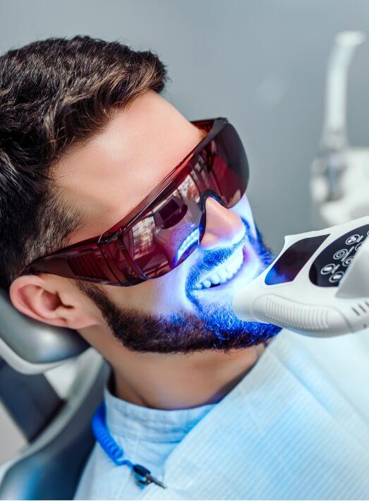 Man getting professional teeth whitening from Los Angeles cosmetic dentist