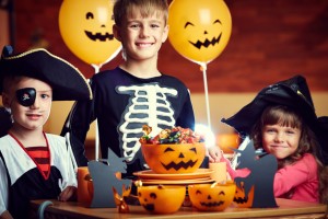 Kids celebrating Halloween with lots of candy. fight cavities with help from your los angeles dentist