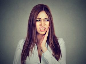 Pained woman needs root canal therapy in Los Angeles