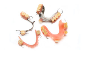 Several different types of dentures in Los Angeles on white background