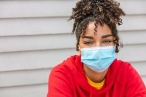 Woman wearing mask using tips from dentist