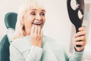 older woman with dental implants in Los Angeles