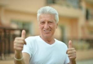 older man happy with dental implants