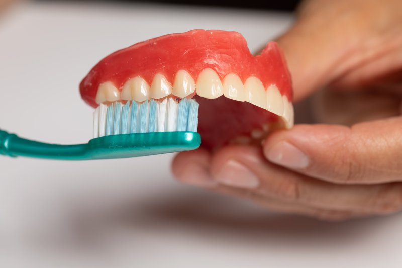 Toothbrush cleaning partial dentures