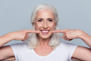 Older woman pointing to her teeth