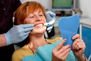 Woman with dentures at dentist