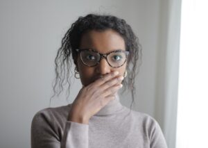 Stunned woman with her hand over her mouth