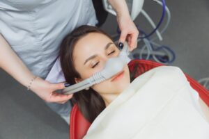 Woman undergoing nitrous oxide for her routine cleaning