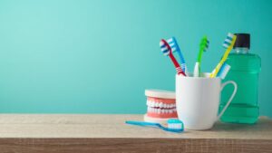Assortment of oral hygiene tools, including toothbrushes, toothpaste, and mouthwash.
